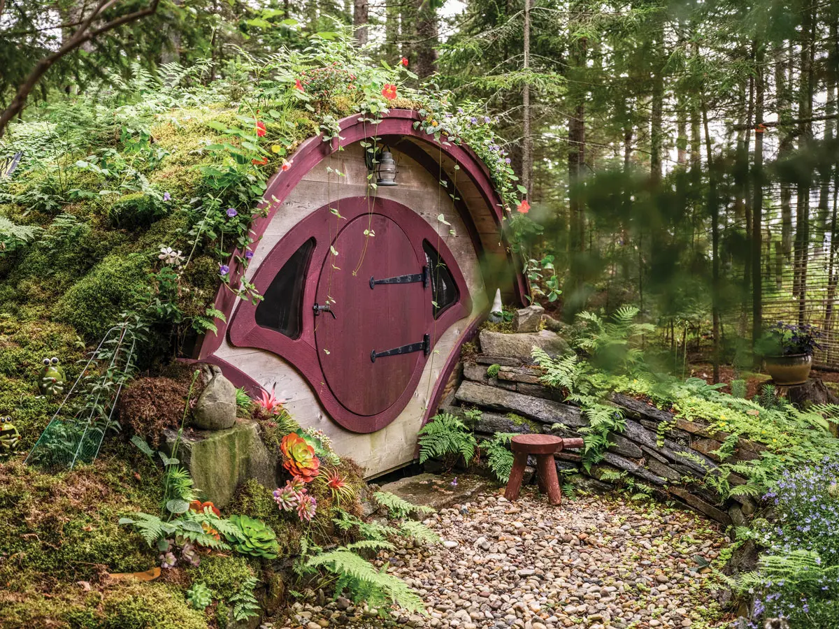 A “hobbit house” planted with moss, ferns, and a few faux blooms.
