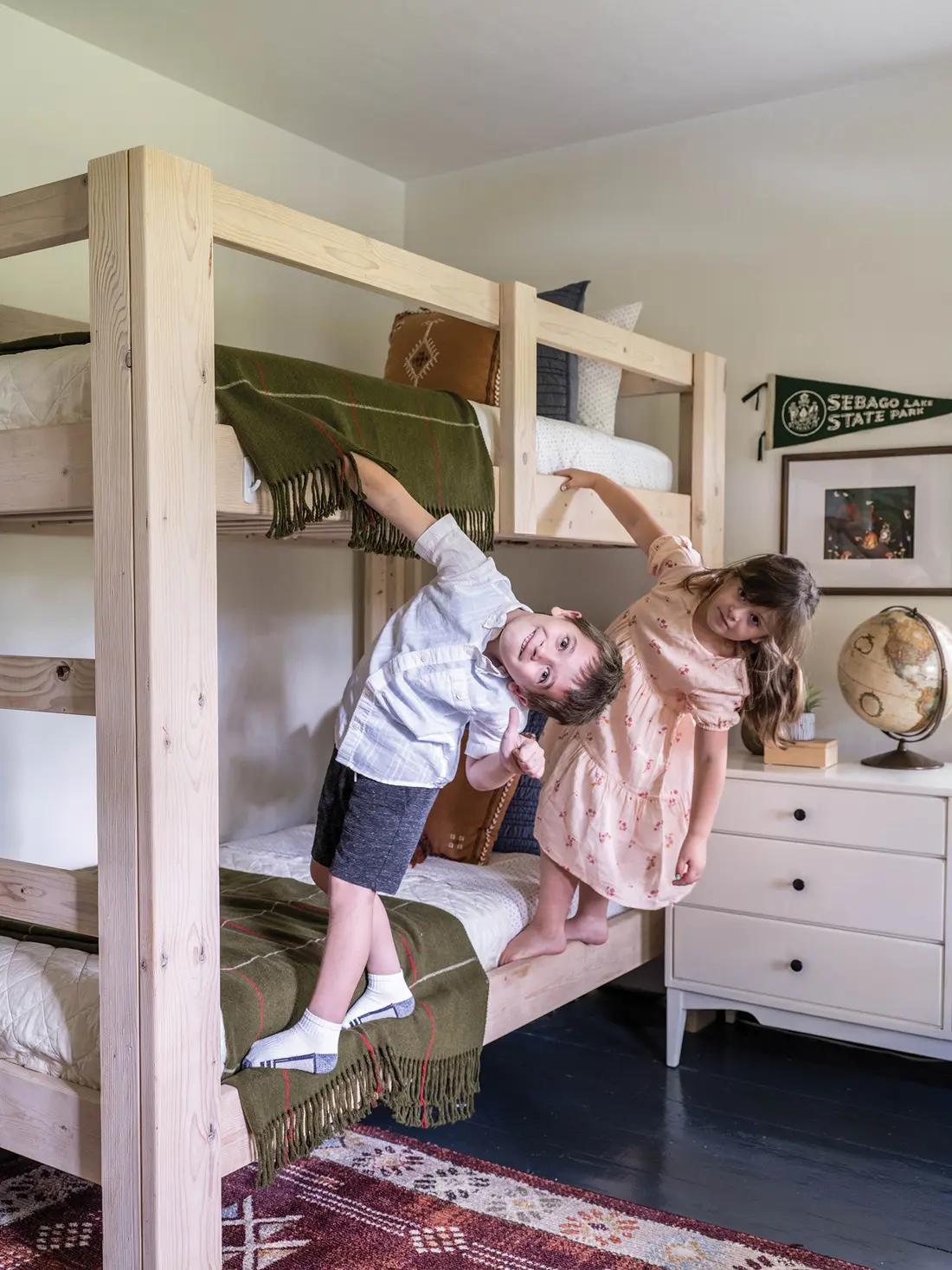 In seven-year-old Richard’s room, he and his six-year-old sister, Evangeline, hang from a pine bunk bed their dad made.