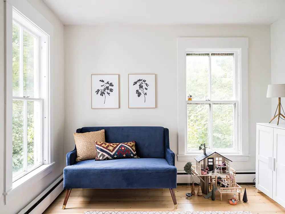 A pillow stitched from a vintage kilim, found at Bridgton’s Scout, picks up the tones in a mid-century–style love seat from Wayfair and botanical prints from Juniper in the playroom