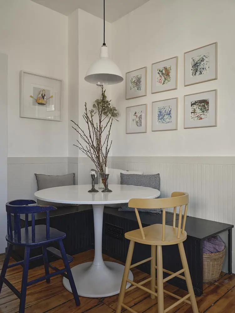 To maximize space in the small kitchen, the couple built a banquette with underseat storage for table linens.