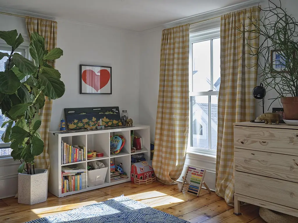 the colorful family room doubles as a guest room, playroom, office, and art studio