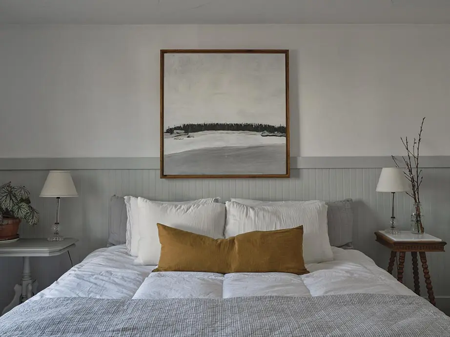 a painting of Ram Island by Patrick Krulik above the bed in the Krulik's primary bedroom