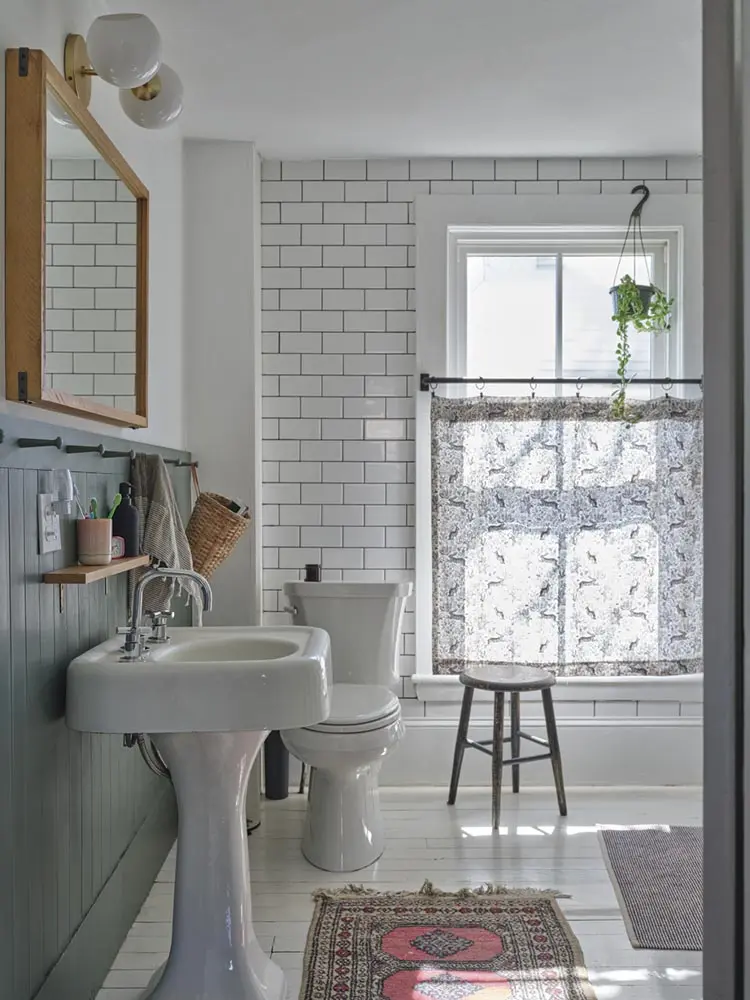 white-and-black bathroom features classic subway tiling with black grout