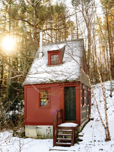red, snow-covered camp in Alna, Maine