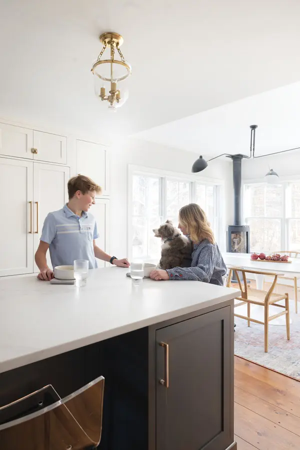 Cameron Zinman, her son, and the family dog at the kitchen counter