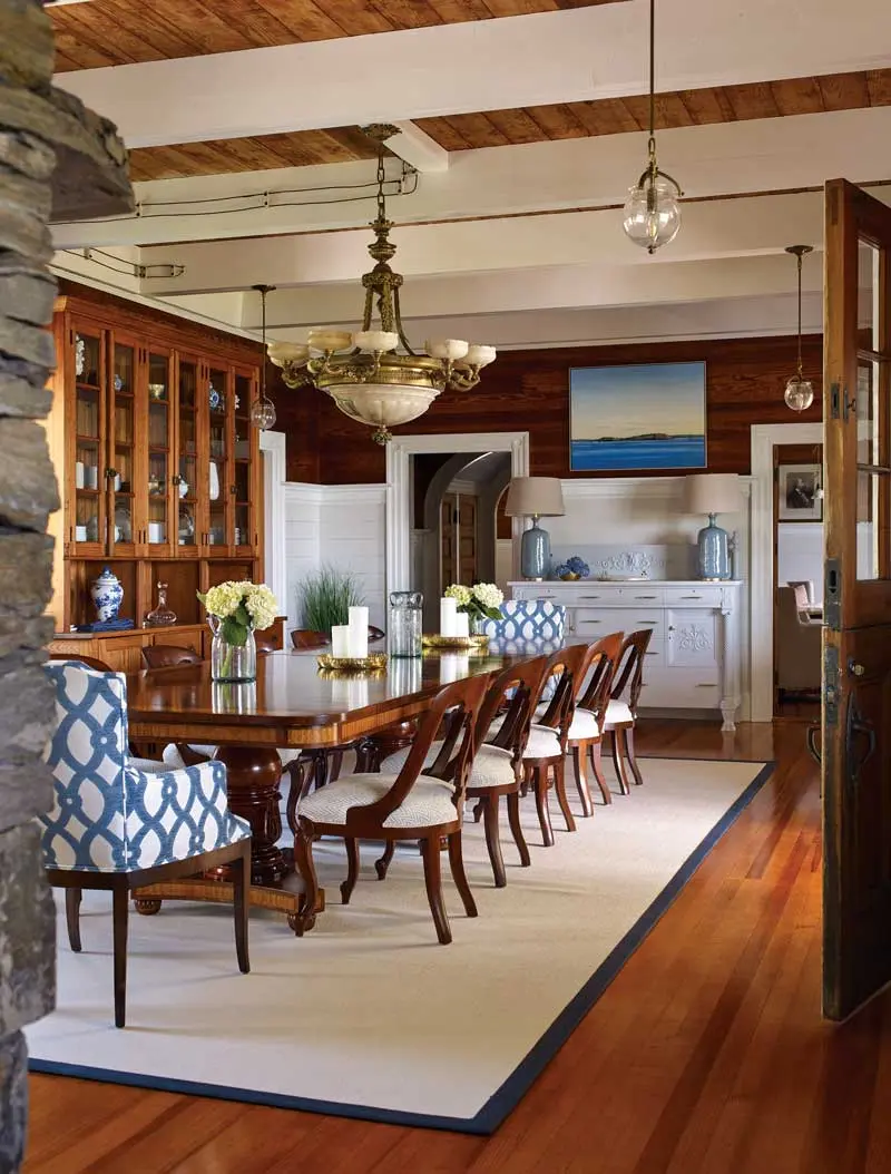 New and antique light fixtures (powered by the island’s 70-kilowatt solar array) crown the dining room, which showcases exposed knob-and-tube wiring. A commissioned painting of Clapboard Island by Waterville’s Matthew Russ — acquired through Erica Gammon of Contemporary Art Maine — hangs above an antique sideboard.