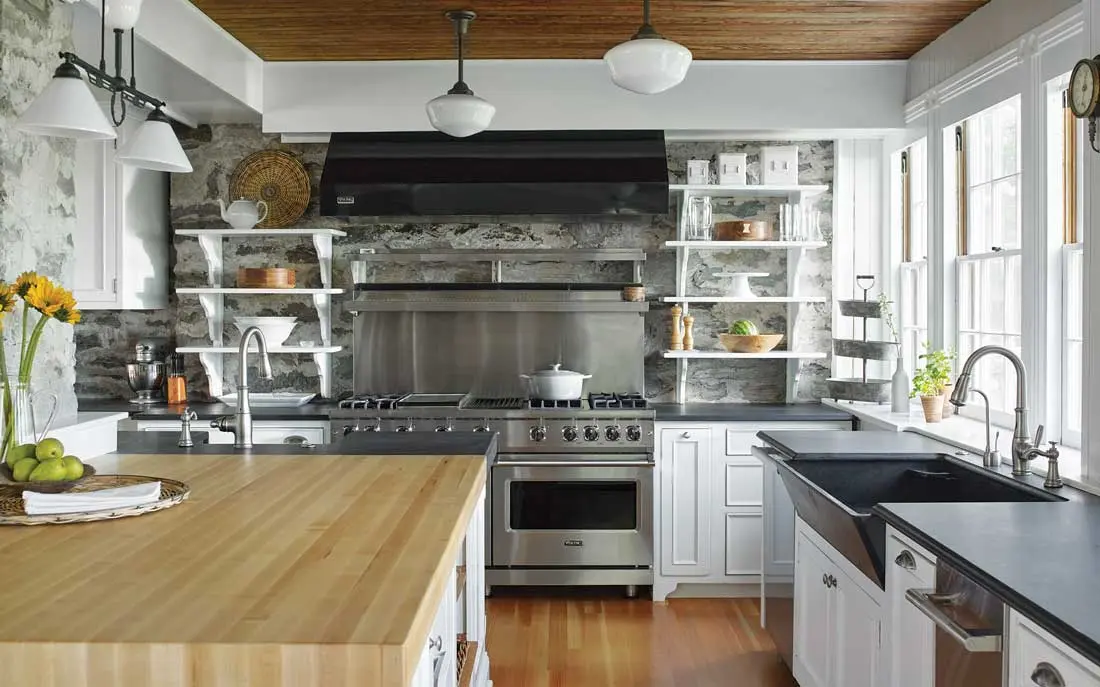 The home’s stone foundation backdrops open shelving in the kitchen, which sports its original slate sink and butcher-block island top.