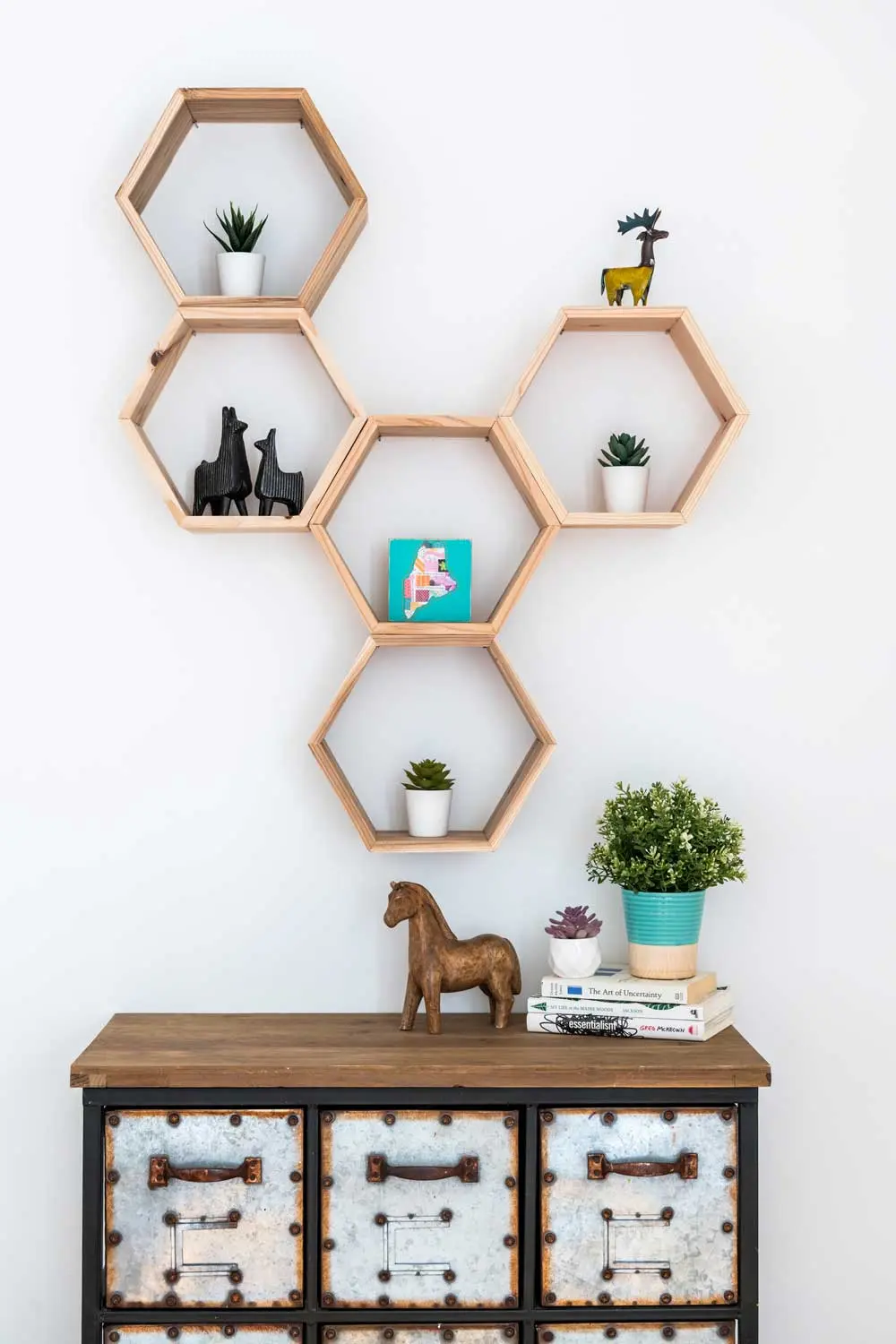 How a House-Flipping Project Became Their Home Honeycomb-like cedar shelves from Etsy and a wood-and-metal apothecary chest display succulents and scrap-metal creatures from Montana’s Stag Lane Primitives.