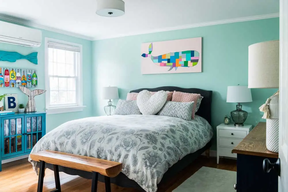 How a House-Flipping Project Became Their Home Breaktime by Sherwin-Williams on the walls and a floral duvet cover reference the colors and motifs from the home's entry