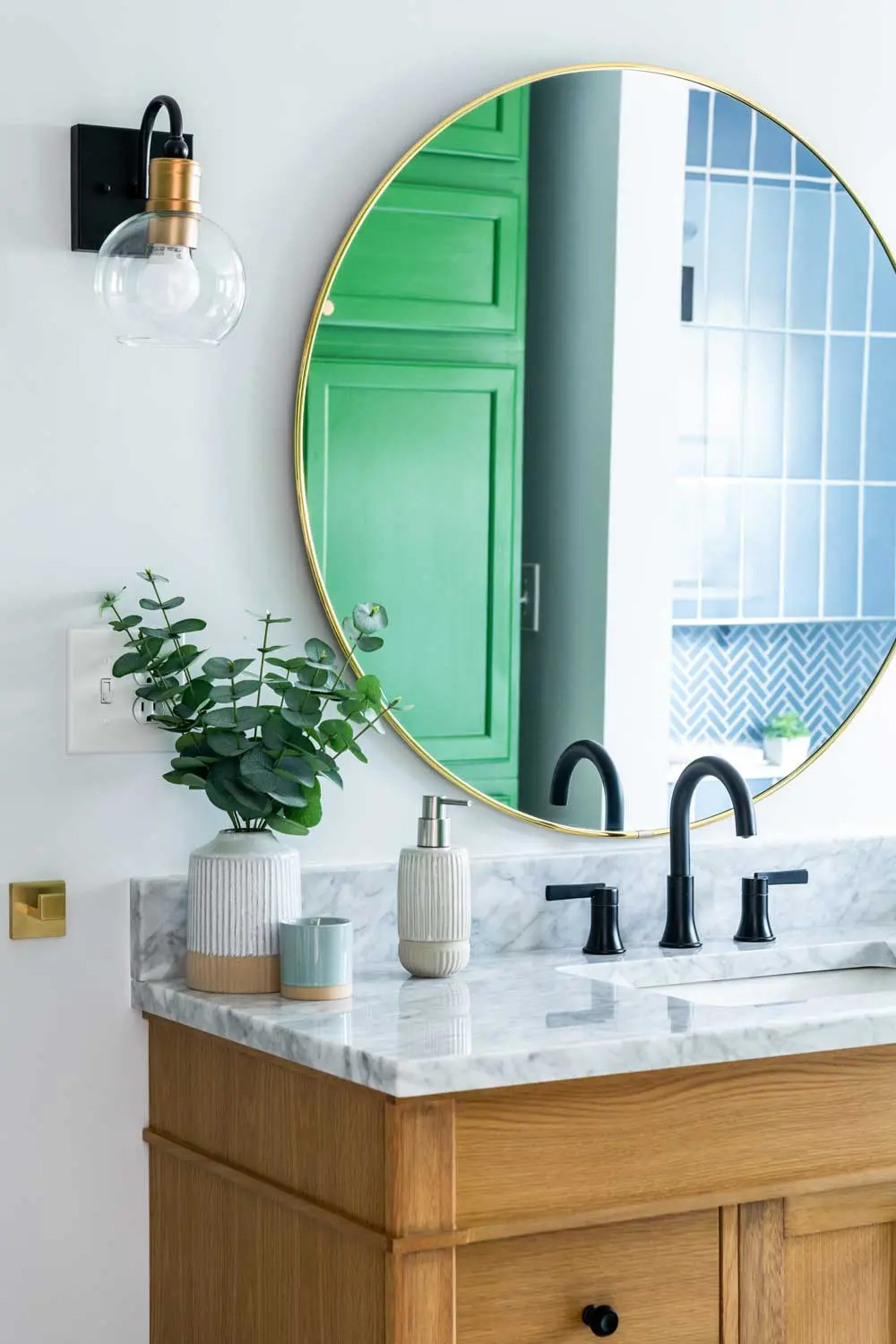 How a House-Flipping Project Became Their Home blue-gray American Olean ceramic shower tile and a “linen closet” comprising stacked Home Depot kitchen cabinets painted in Sherwin-Williams’s Talipot Palm