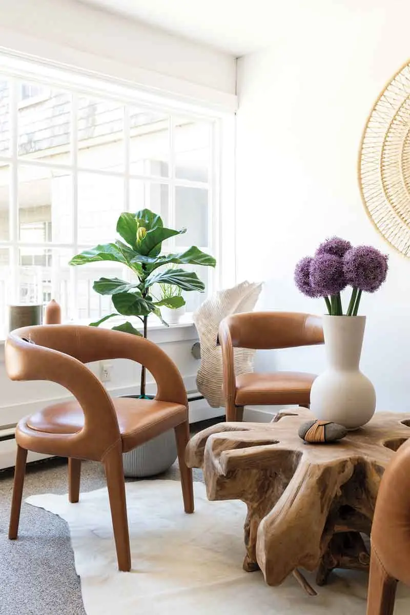 leather chairs pair with an Indonesian teak-root table, a one-of-a-kind market find.