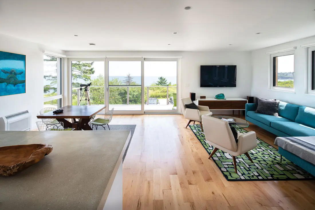Dreaming of Building a Green Retreat? A sofa and rug from Portland’s Youngs Furniture and Angela Adams define the living area.