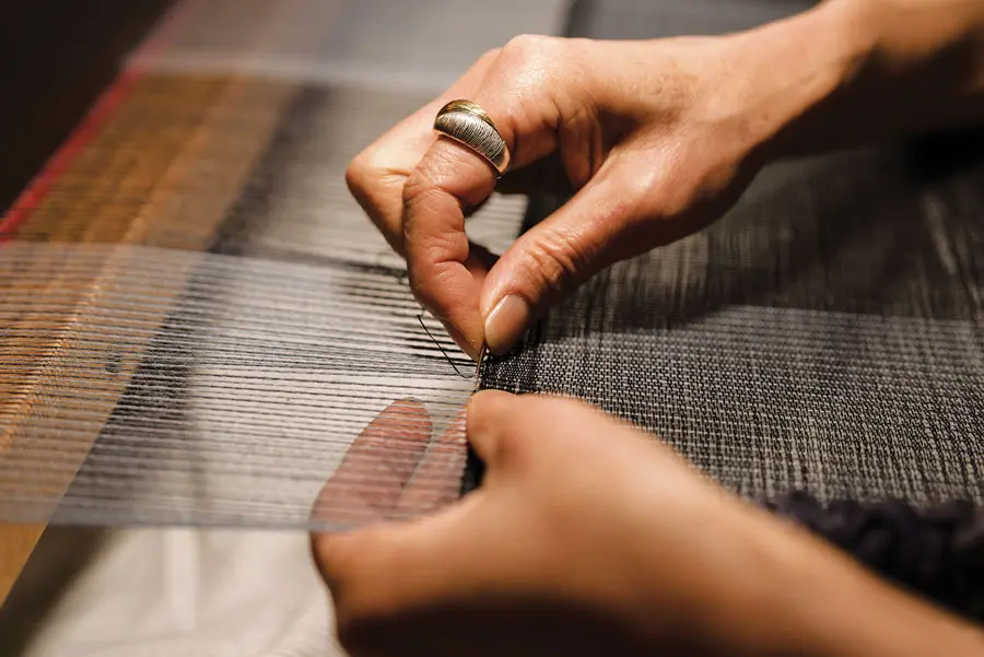 Emi Ito weaving at her a Swedish countermarch loom