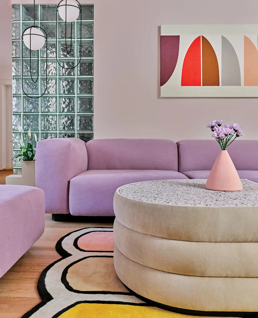 MHSpring2021_prof3 Rounded forms reign in the family room, featuring a Vitra sofa, Kimmy Quillin acrylic, and Pieces coffee table and rug.