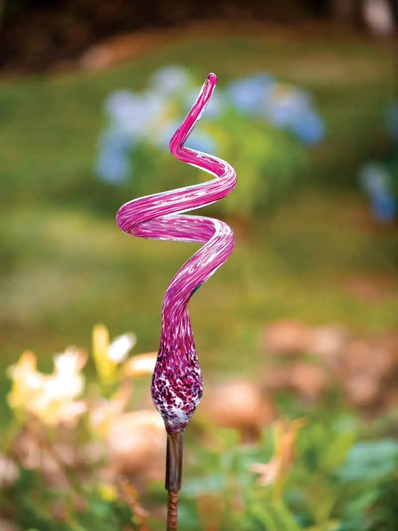 Scores of Colorful Glass Orbs Lend Continuity to This Harpswell Garden a handblown glass curlicue sculpture by Sigwarth