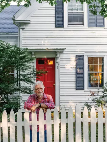 Writer Eliot Daley stands in front of the Waldoboro farmhouse his family acquired decades after it was sold by his son-in-law’s grandparents.