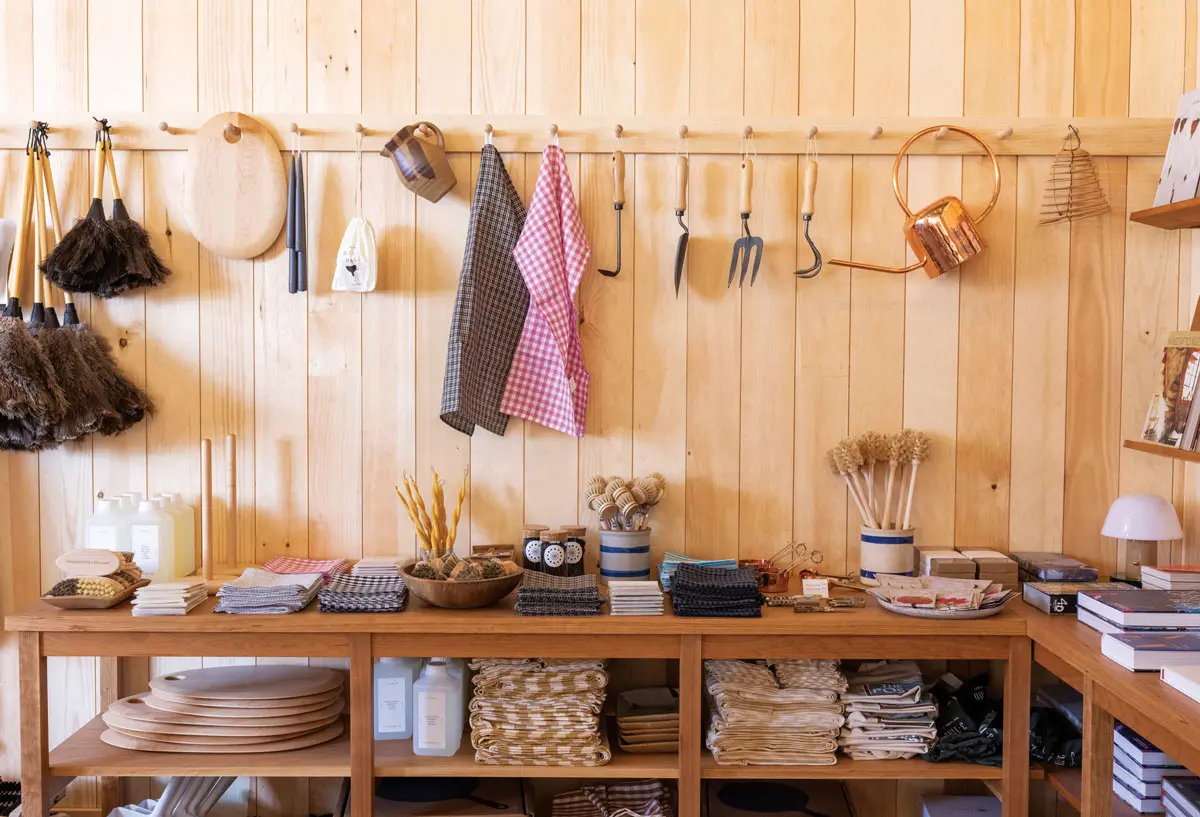 Wood-handled tools; maple cutting boards; stoneware dishes; gingham linens; copper watering cans; tapers by Rockport’s Danica Design Candles; custom quilts by Yarmouth’s Smith’s General; and co-owner Katie Bowes await at The Post Supply, in Portland.