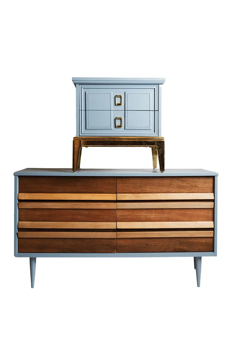 a mid-century wood- and-slate-gray dresser and coordinating nightstands with gold-leaf bases