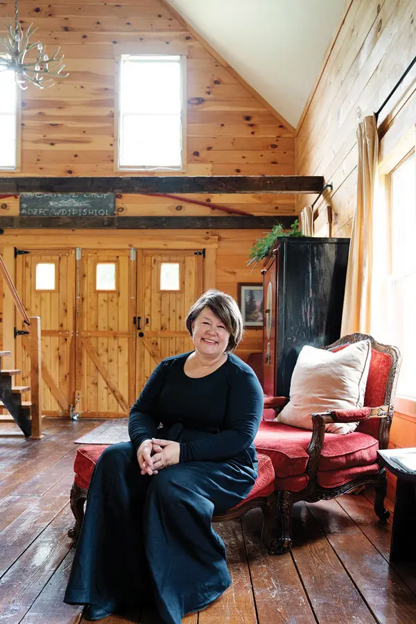 Brenda Schultz (seated) filled the former shop with antiques, such as the dining area’s 1850s cabinet from Central Maine Antique Mall, in Bangor, and 1920s chandelier.