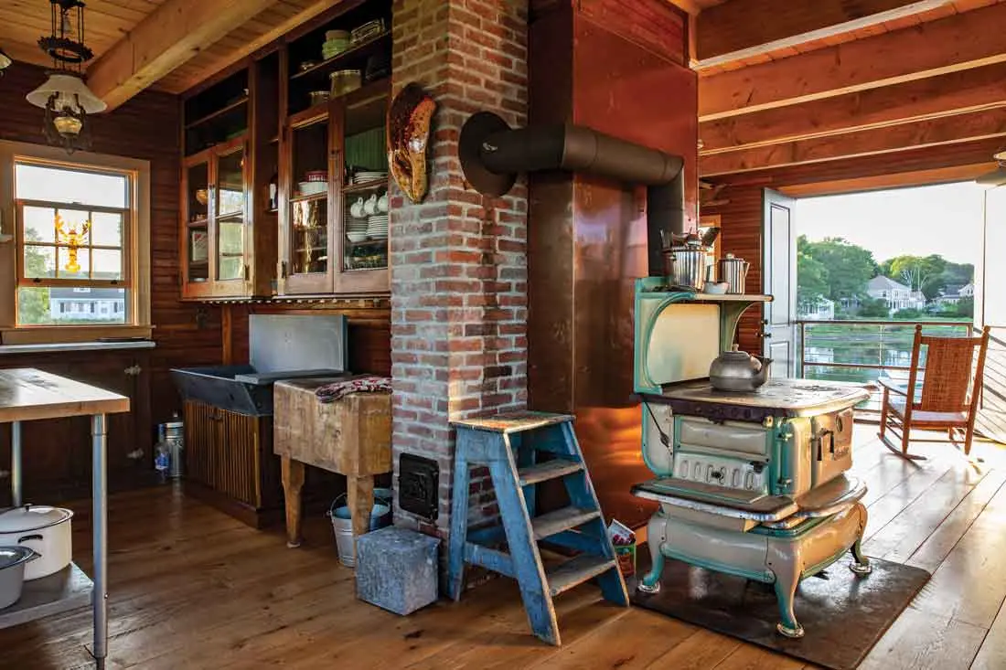 A cast-iron Atlantic stove — Zuke has salvaged dozens — warms the house on chilly days