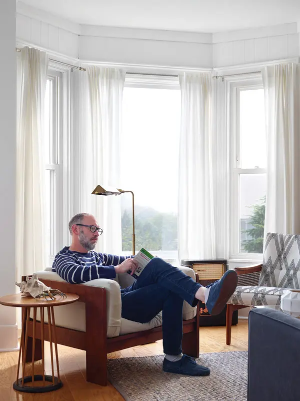 An original bay window provides a peaceful reading spot in the living room.