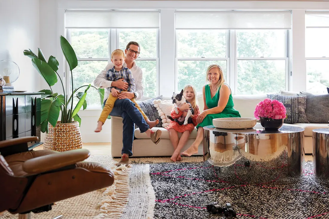 Gavin and Carly Blackmore, their son, Lawson, daughter, Maeve, and Boston terrier, Tux, in their Falmouth living room.