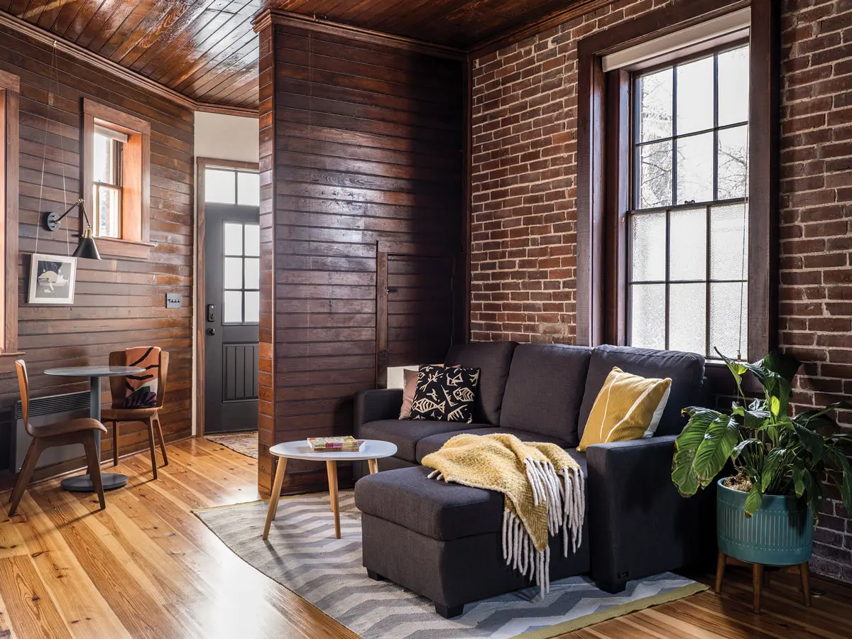 A pine wall with a feed hatch sets off the entry in Lauren and Keith Rosenberg’s Portland carriage-house-turned-guest-quarters.
