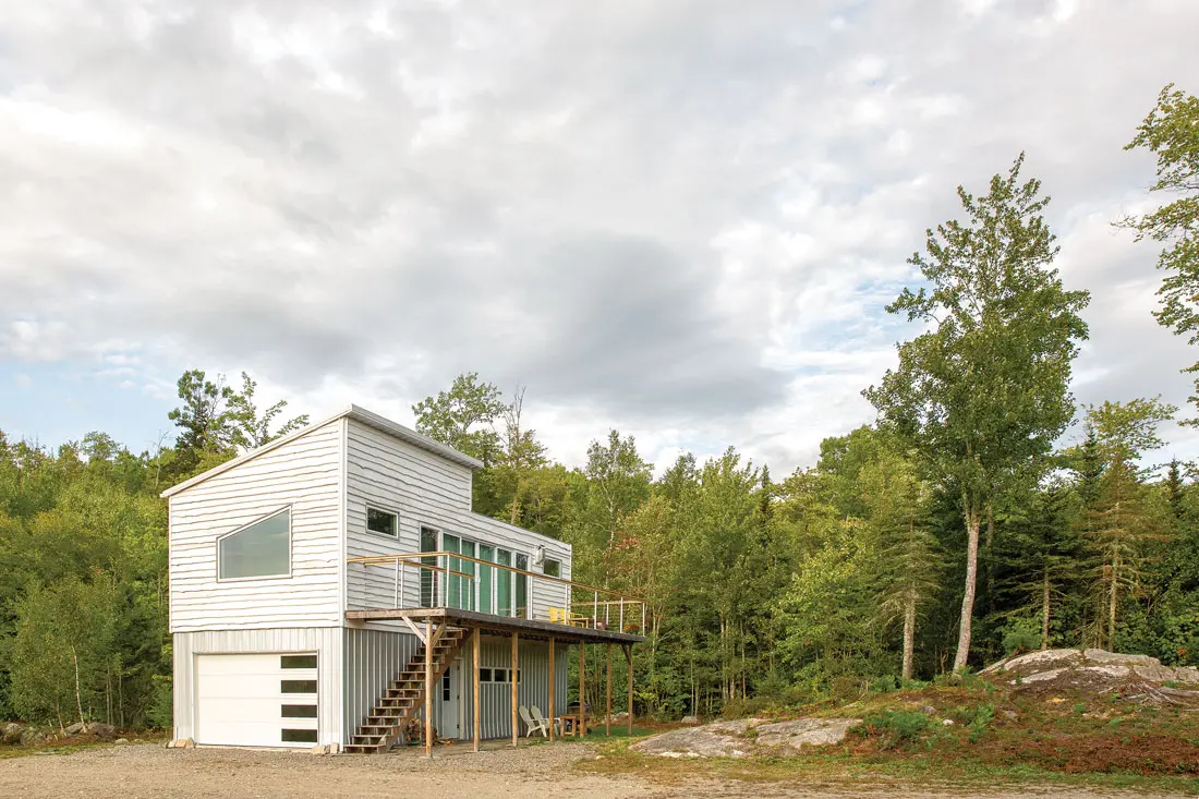 Jen Sansosti and Steve White’s modified container home perches in a two-acre clearing overlooking a pond on a 63-acre Brooklin plot.