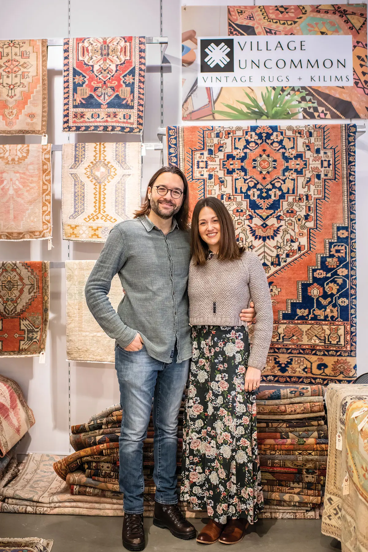 Village Uncommon’s Murat and Ami Unal, pictured in their Freeport shop, source mid-century, handwoven Anatolian rugs (from the Asian region of modern Turkey), as well as pillow covers stitched from salvaged kilims.