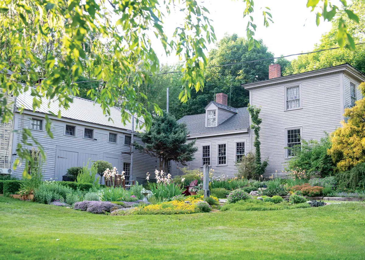 Herb and perennial gardens flourish near the entrance to Edith and Joel Ellis’s 19th-century Turner home.