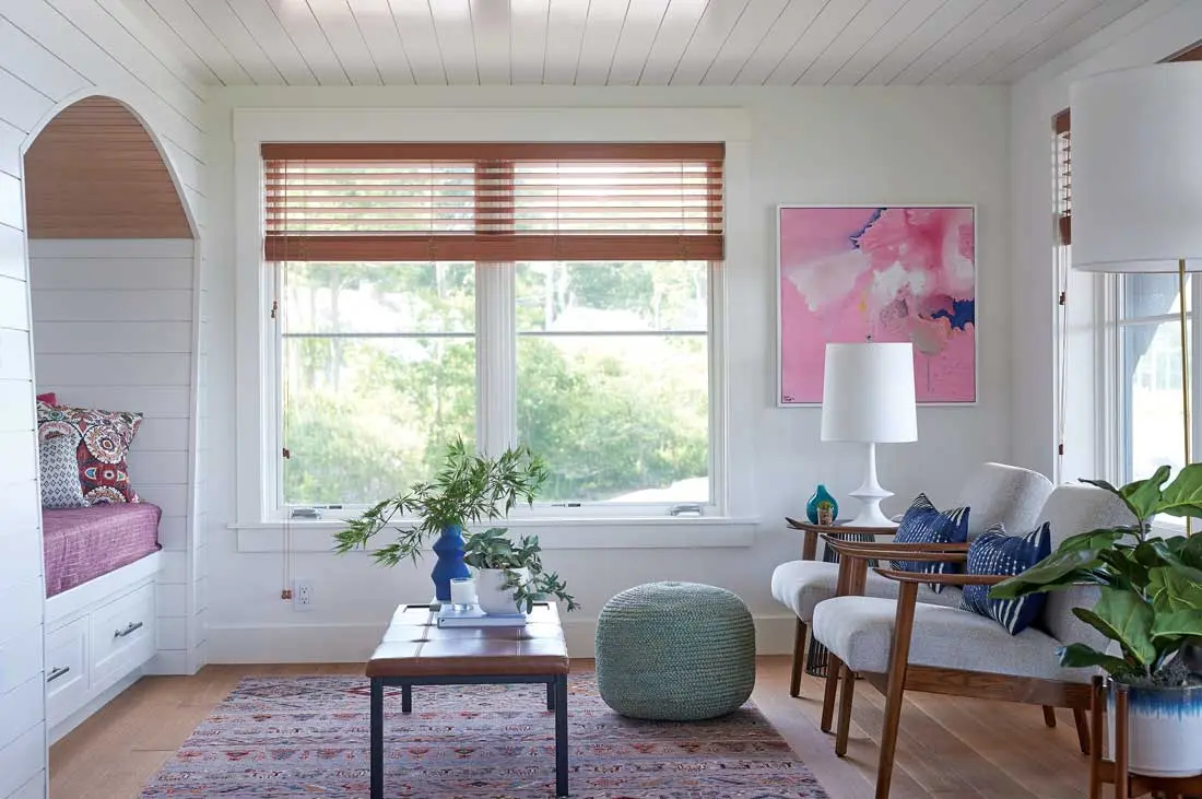 Pops of pink in an abstract painting and Peter Dunham fabrics warm the lower-level living area.