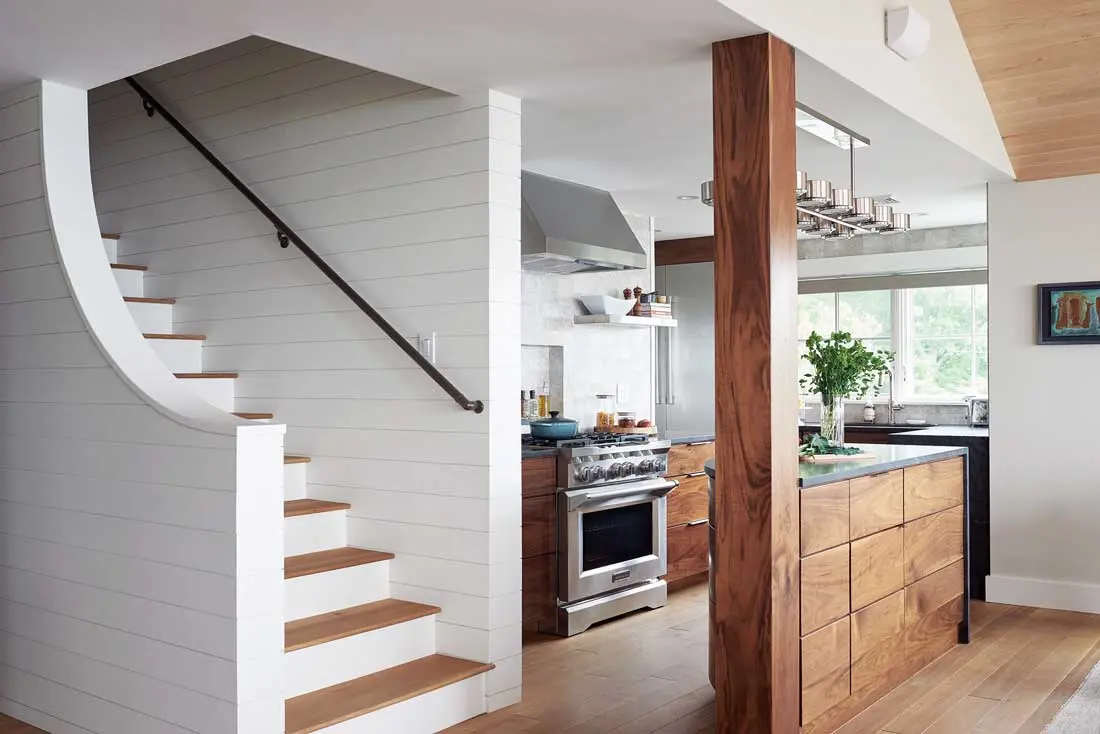 In the kitchen, honed black-granite countertops from Portland’s Paul White Company pick up the darkest tones in swirly walnut cabinetry