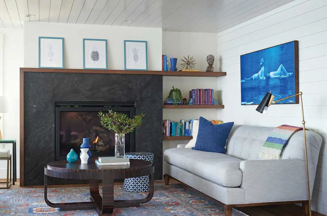 An arresting cyanotype by Portland’s Ramble More Design sets the laid-back tone in a lower-level living room nook whose other focal point is an oak-wrapped fireplace that cleverly integrates floating shelves.