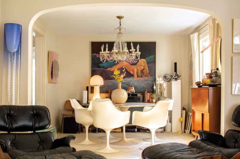 In the dining room, a 1970s-era nude by Alex Tavoularis peeks out over a Saarinen Tulip table and chairs, a cheekily suggestive 1960s glass mushroom lamp, and a bulbous 1970s vase