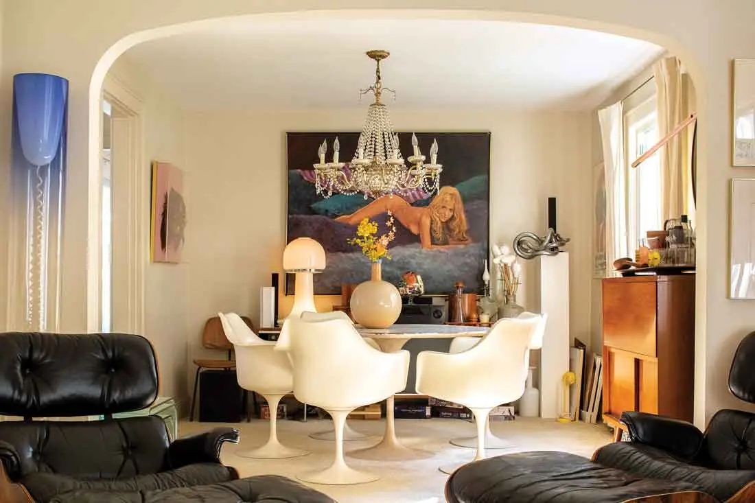 In the dining room, a 1970s-era nude by Alex Tavoularis peeks out over a Saarinen Tulip table and chairs, a cheekily suggestive 1960s glass mushroom lamp, and a bulbous 1970s vase