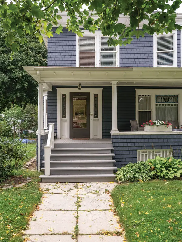 When the butter-yellow shingles needed repainting, Julianne Gilland went with Behr’s Undersea, a dark shade like she’d seen in an early photograph.