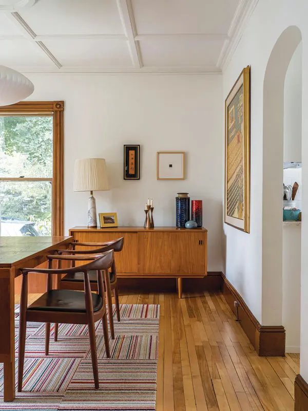 a circa 1960s Danish teak console topped with an Italian marble lamp and ceramics; a 1970s Danish teak dining table and circa 1960 teak Hans Wegner chairs; and a giant 1972 Dorothy Cutter painting
