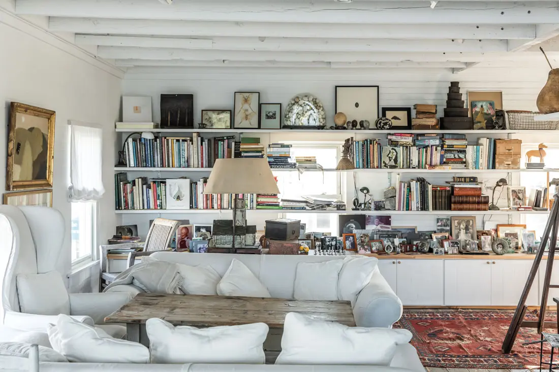 In Sharon and Paul Mrozinski’s collection-packed living room on Vinalhaven, an antique orchard ladder leads to a sleeping loft for their grandchildren.