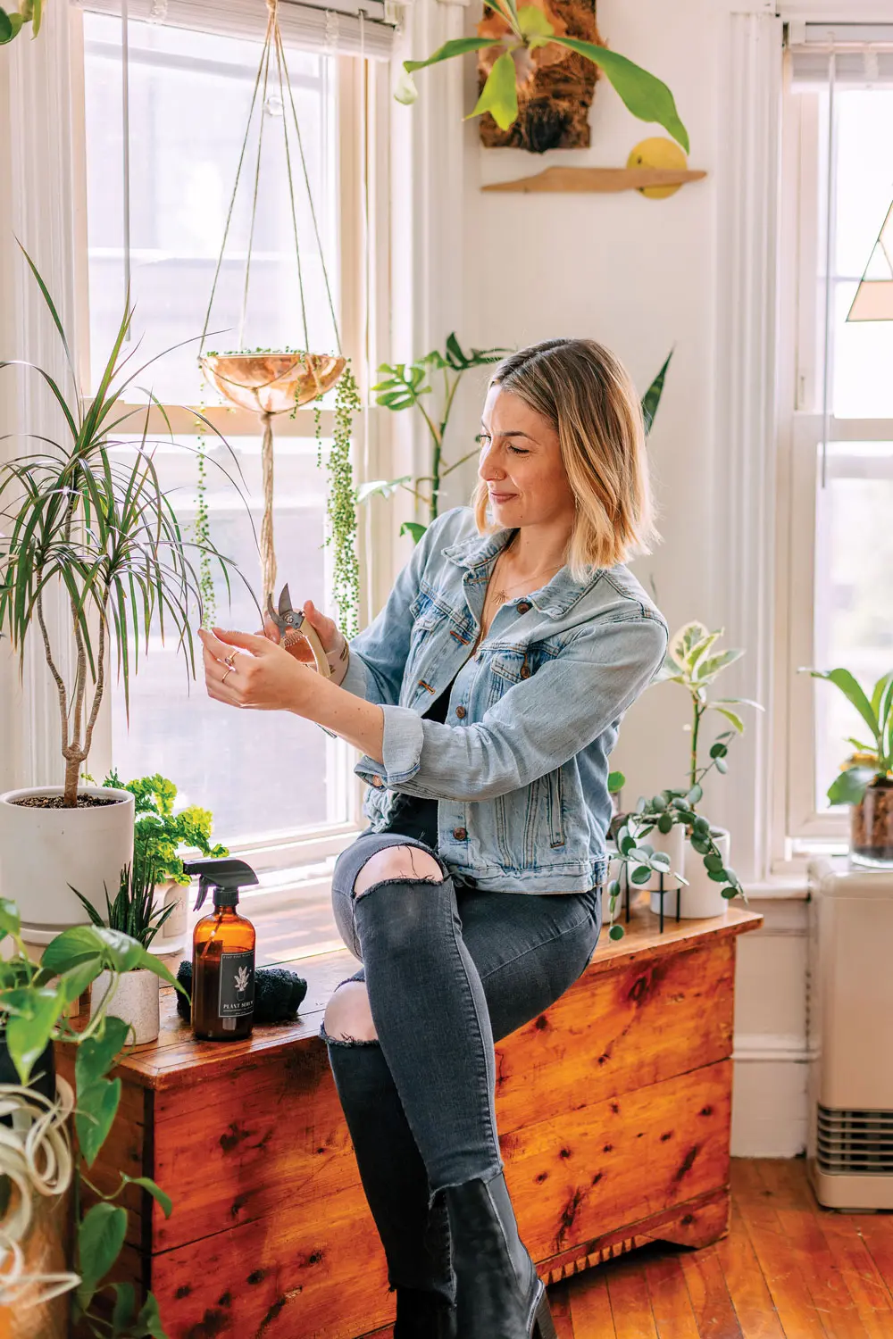 Amalia Bussard tending to plants in her Portland apartment