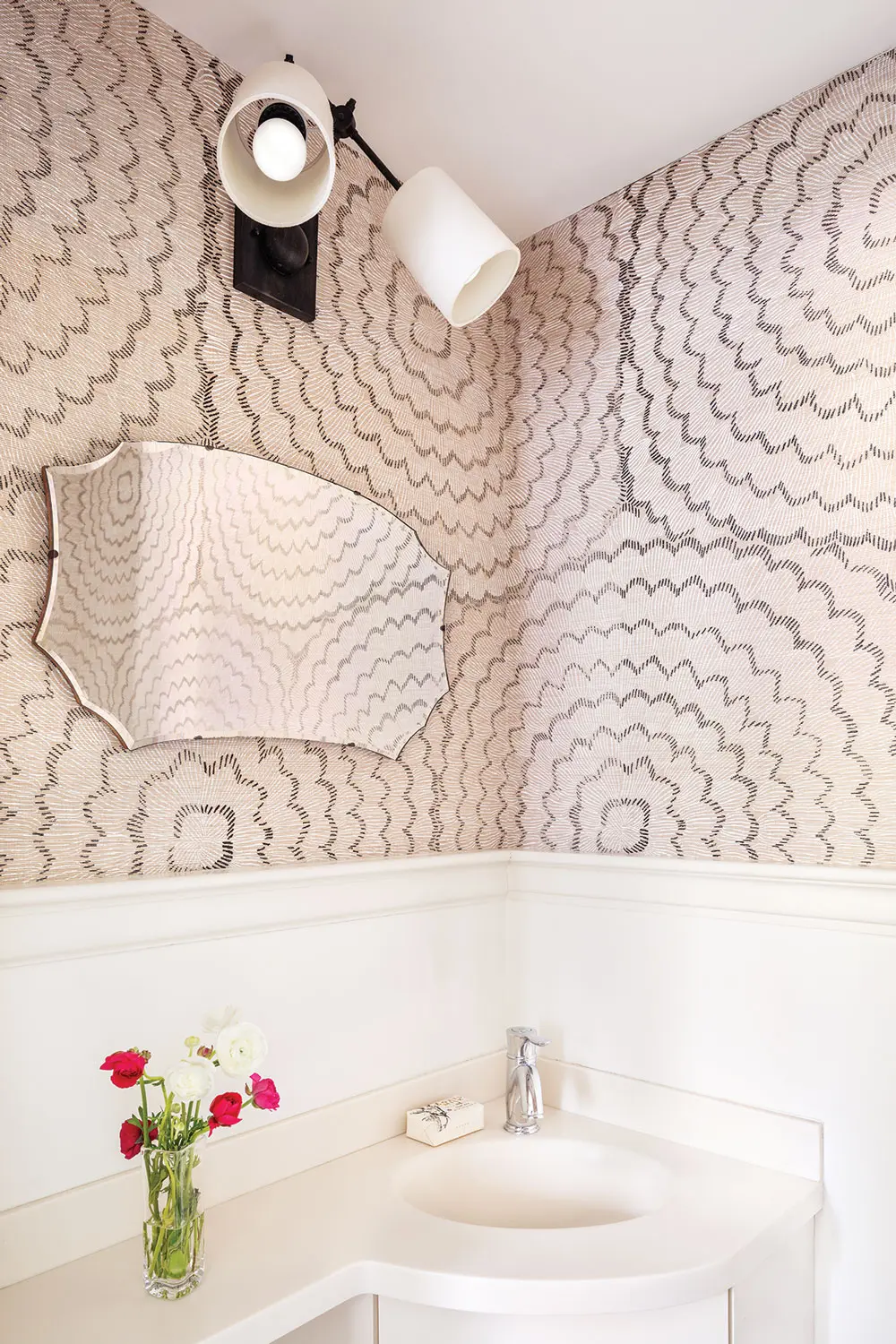 South Portland designer Bronwyn Huffard left an existing vanity in place and added abstract-floral sisal wallpaper, by Schumacher.