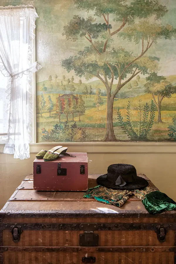 Preserving a 19th-Century Writer's Party Pad Kate Douglas Wiggin’s beaded-velvet pumps, beaver-fur hat, and embroidered-velvet bolero are displayed on her steamer trunk in the bedroom with the Porter mural.