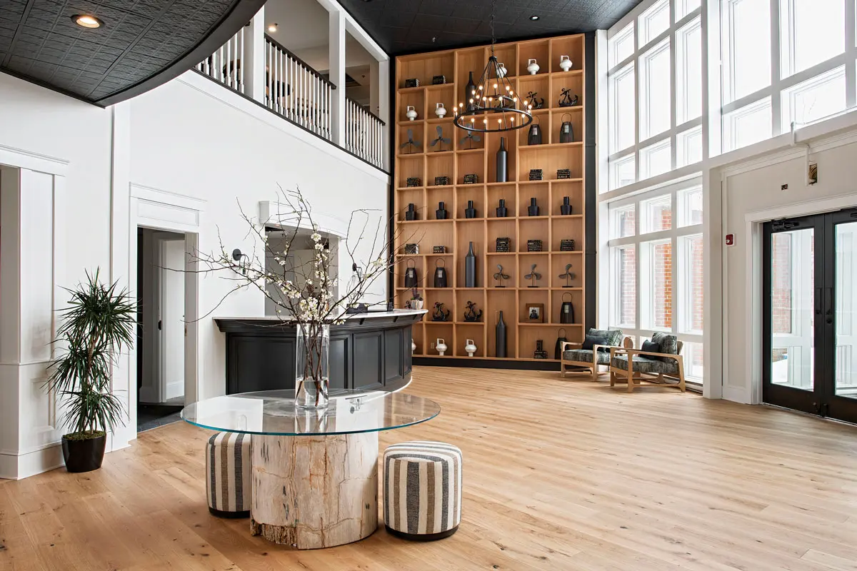 Among the visual delights in Brunswick’s new hotel, The Federal: the lobby’s 20-foot-tall oak bookshelf and petrified-wood table.