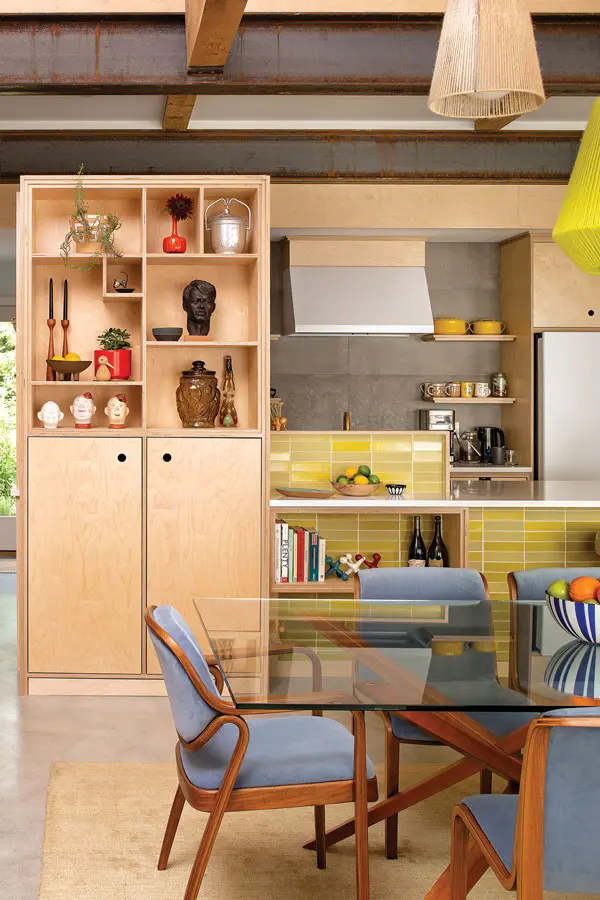 A birch-plywood cabinet designed by the homeowners displays vintage trinkets, like Sabatino’s grandmother’s ice bucket and a 1968 bust of Robert F. Kennedy.