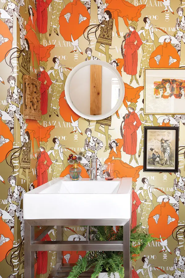 In the powder room, a 1965 print and an 1884 cartoon skewering Maine politician James Blaine project from vintage foil wallpaper