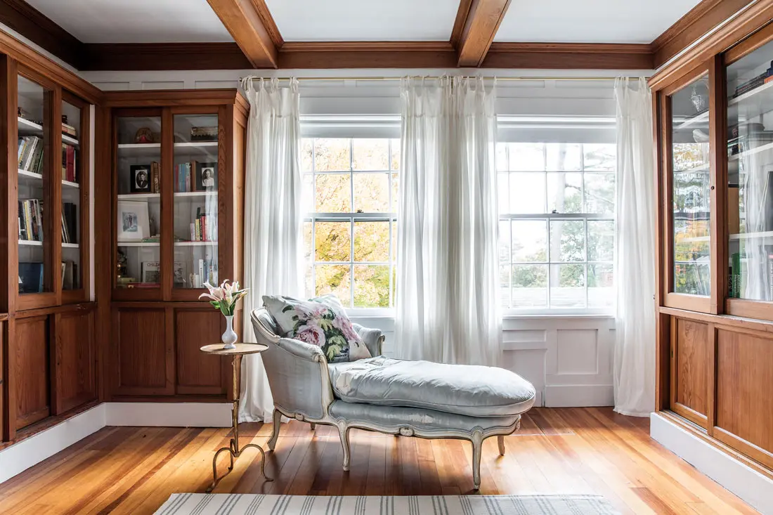 An antique Gustavian chaise lounge from Pillars is a favorite snuggling spot in youngest daughter Greta’s room.