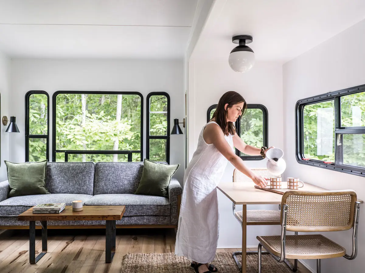 A 2003 Montana Keystone RV Gets a Mod DIY Makeover Theslide-outliving area in Meredith Brockington and Joe Graffius’s RV has a sofa and lights from All Modern, a coffee table from Portland Architectural Salvage, and a plywood table with Terra Sol mugs and a cutting board by Portland’s Treeline