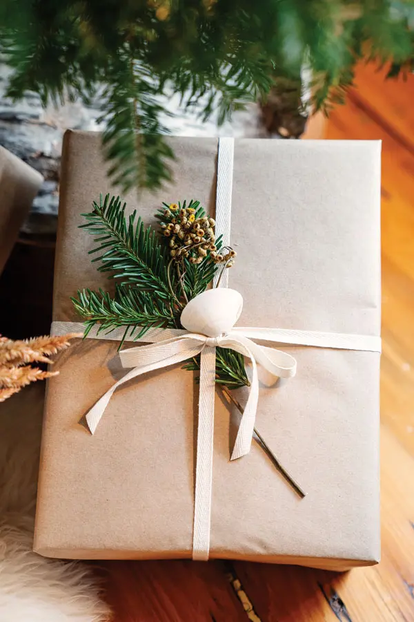 leftover greenery and shells used as decorative touches on Christmas gifts