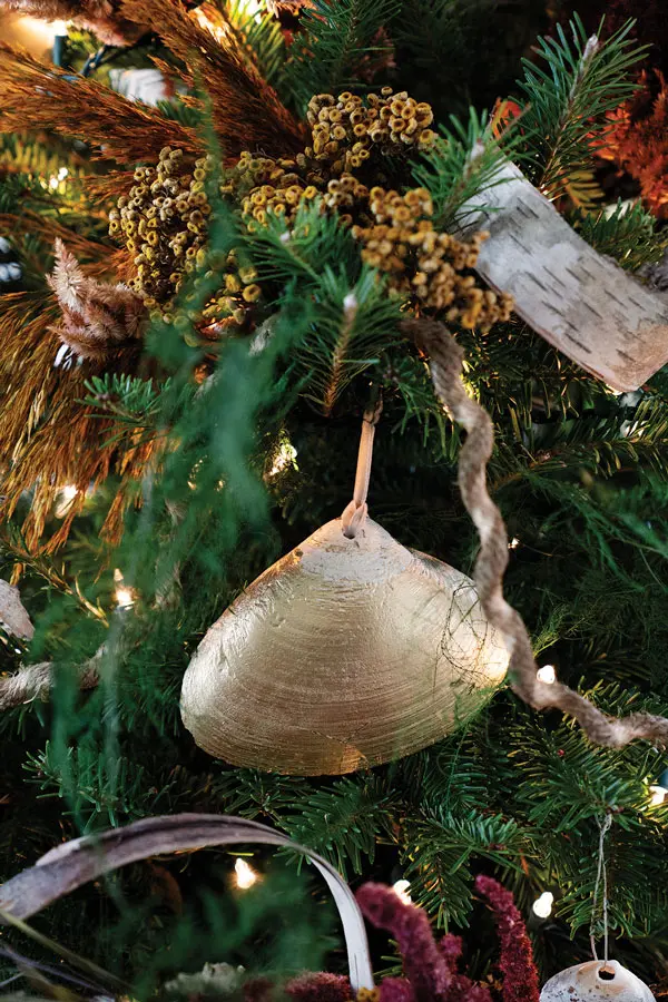 Clamshells spray-painted gold hand as ornaments on a Christmas tree