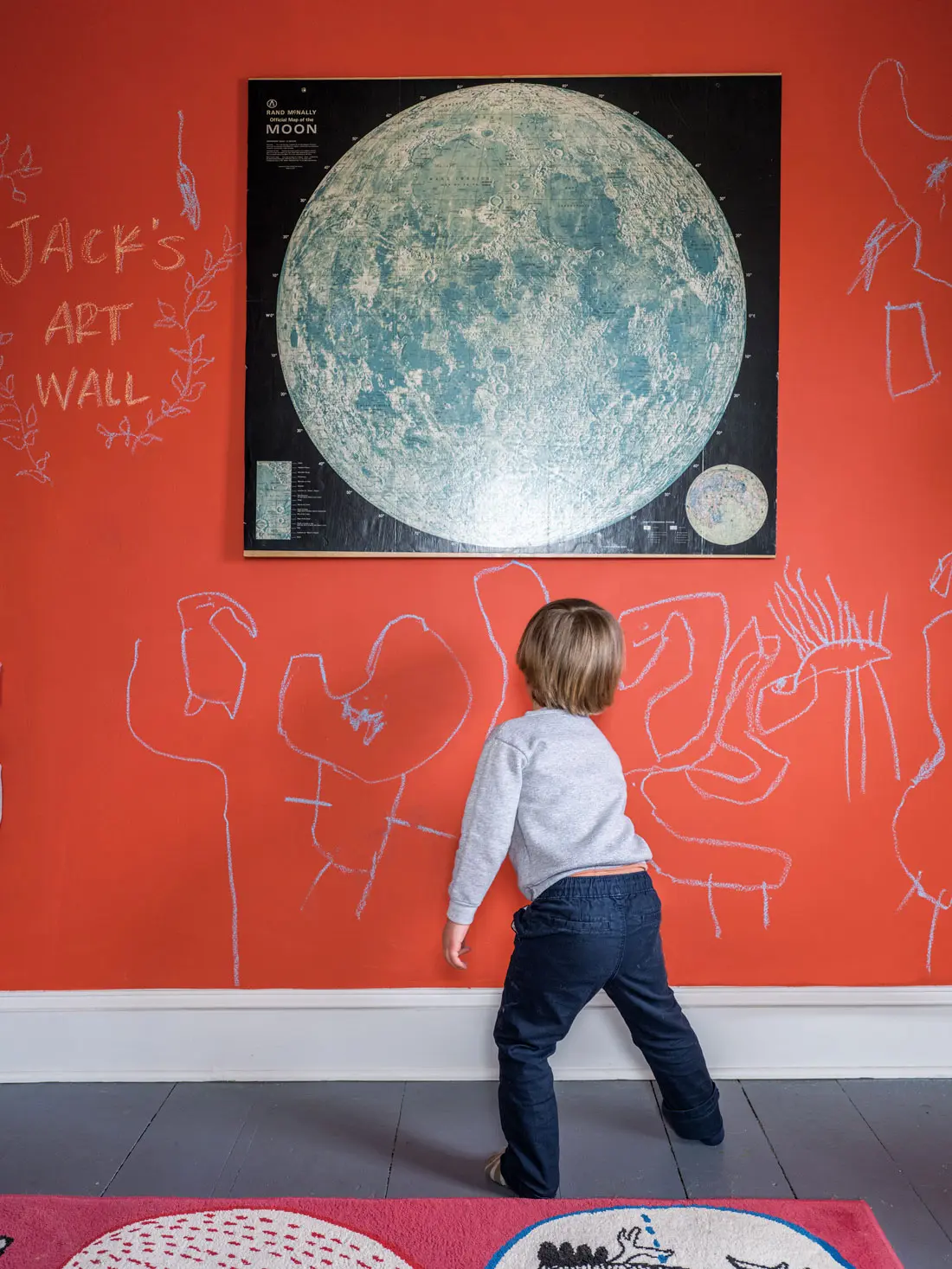 Christina Watka and Andrew Halchak's four-year-old son Jack lets loose on his room’s art wall, created with chalkboard paint tinted in Valspar’s Terra Cotta Red