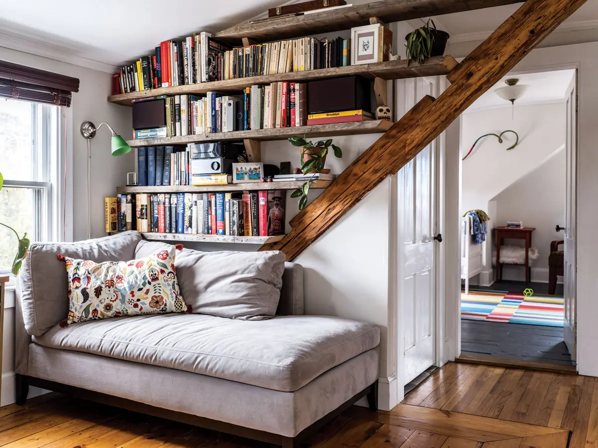 The first thing the couple did was install shelves — these are made from wood salvaged from the barn — in the second-floor library to hold 17 moving boxes worth of books.